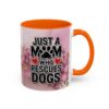 Ceramic mug with 'Just A Mom Who Rescues Dogs' text and floral graphic. Orange handle and interior.