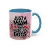 Ceramic coffee mug with blue handle featuring 'Just a Mom Who Rescues Dogs' text and pink floral watercolor design.