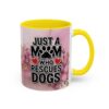White ceramic mug with yellow handle and interior features 'JUST A MOM WHO RESCUES DOGS' text and pink floral design.