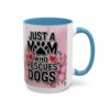 White coffee mug with blue interior and handle, featuring 'Just a Mom Who Rescues Dogs' text, paw print, and floral graphic.