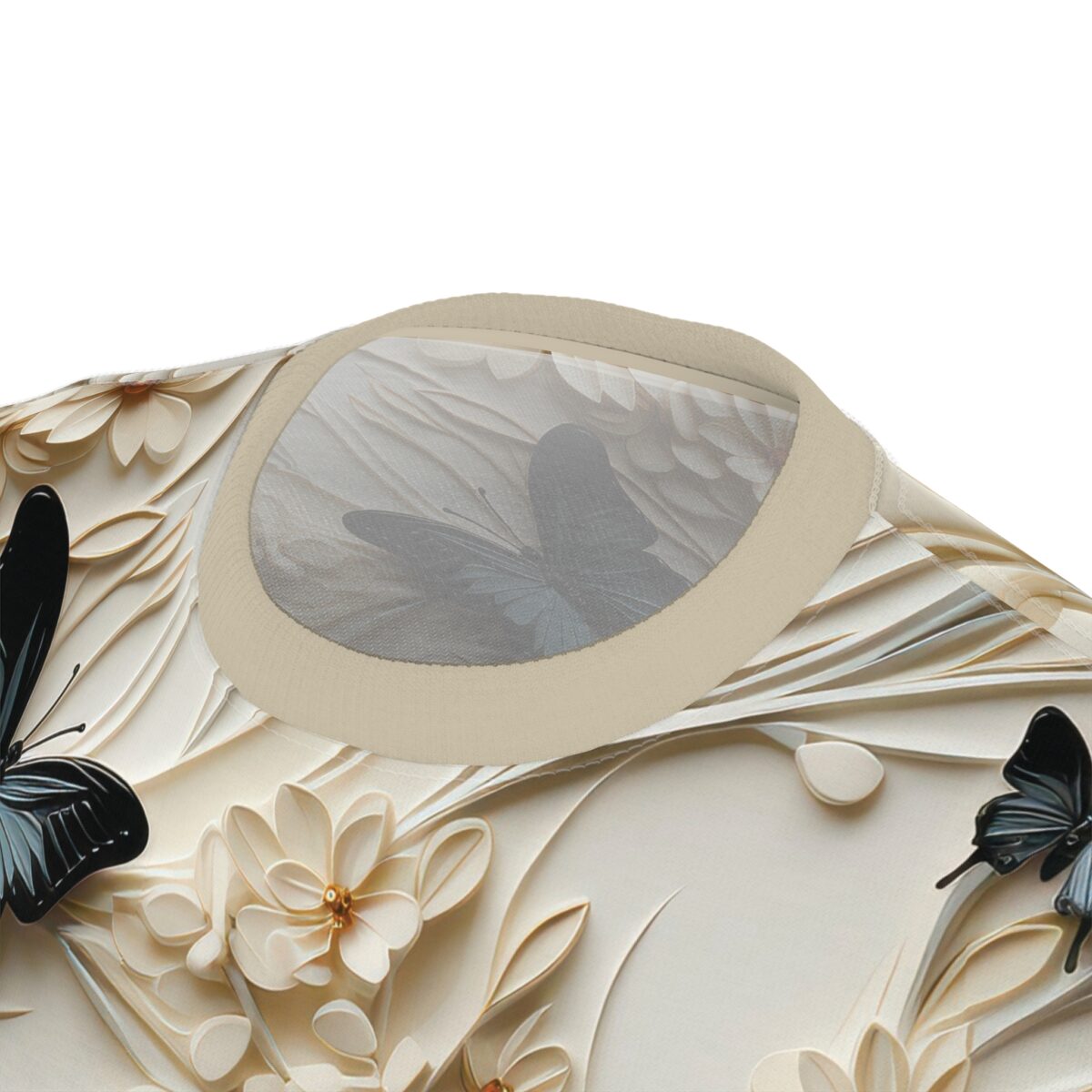 A close-up of a garment with intricate embroidery featuring black butterflies and delicate cream-colored flowers, with a subtle pattern of larger, faded butterflies visible on the fabric behind the embroidery.