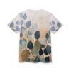 Blue and green watercolor leaves on a tan wash background cover this all over print t-shirt, with delicate brown branches.