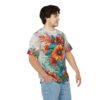 Vibrant floral all over print sublimation tee featuring bold orange and red blooms with lush green leaves on a light grey background.