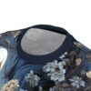 Deep blues and muted golds cover this sublimation graphic tee, with delicate floral patterns and hints of a skull motif.