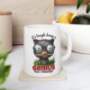 White ceramic mug with a cartoon cat wearing glasses and holding a pencil, text reads 