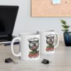 White ceramic mug with a humorous graphic of a cat wearing glasses and a pencil.