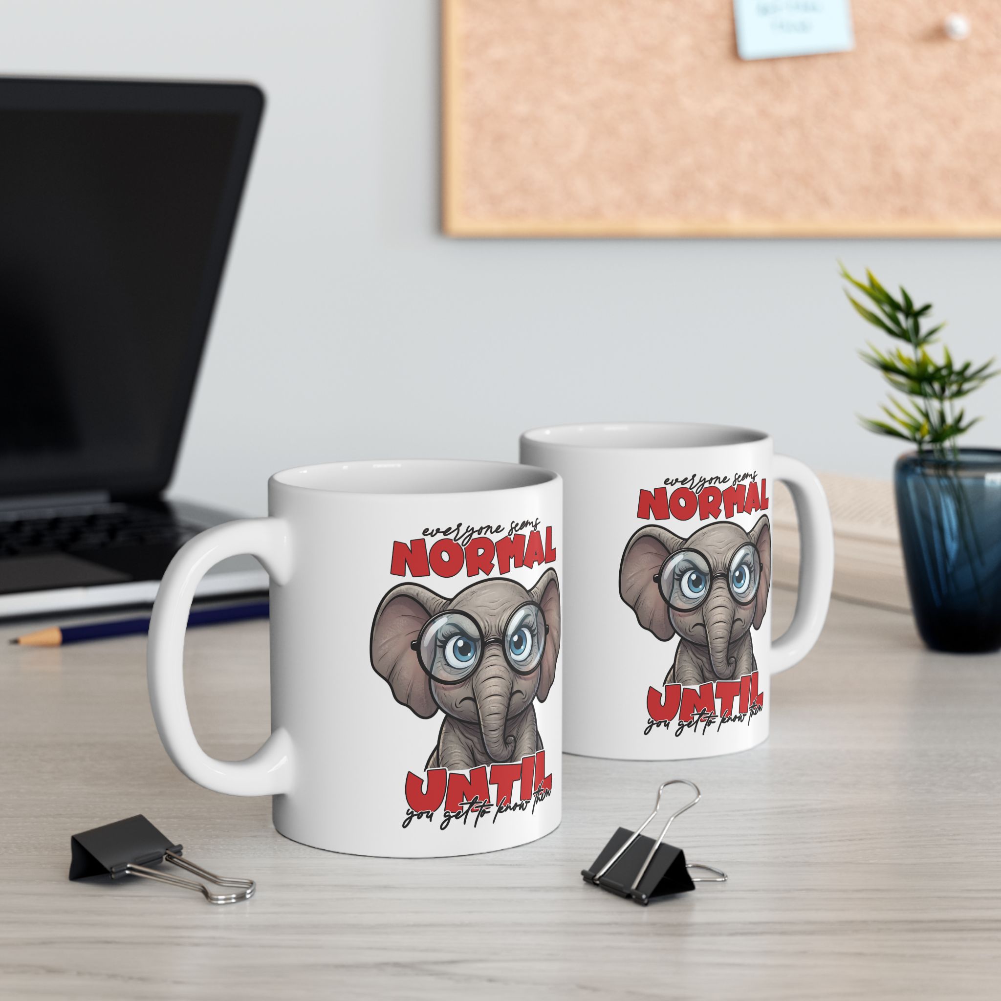 White ceramic mug with a humorous illustration of a cartoon elephant wearing glasses and a sarcastic expression.