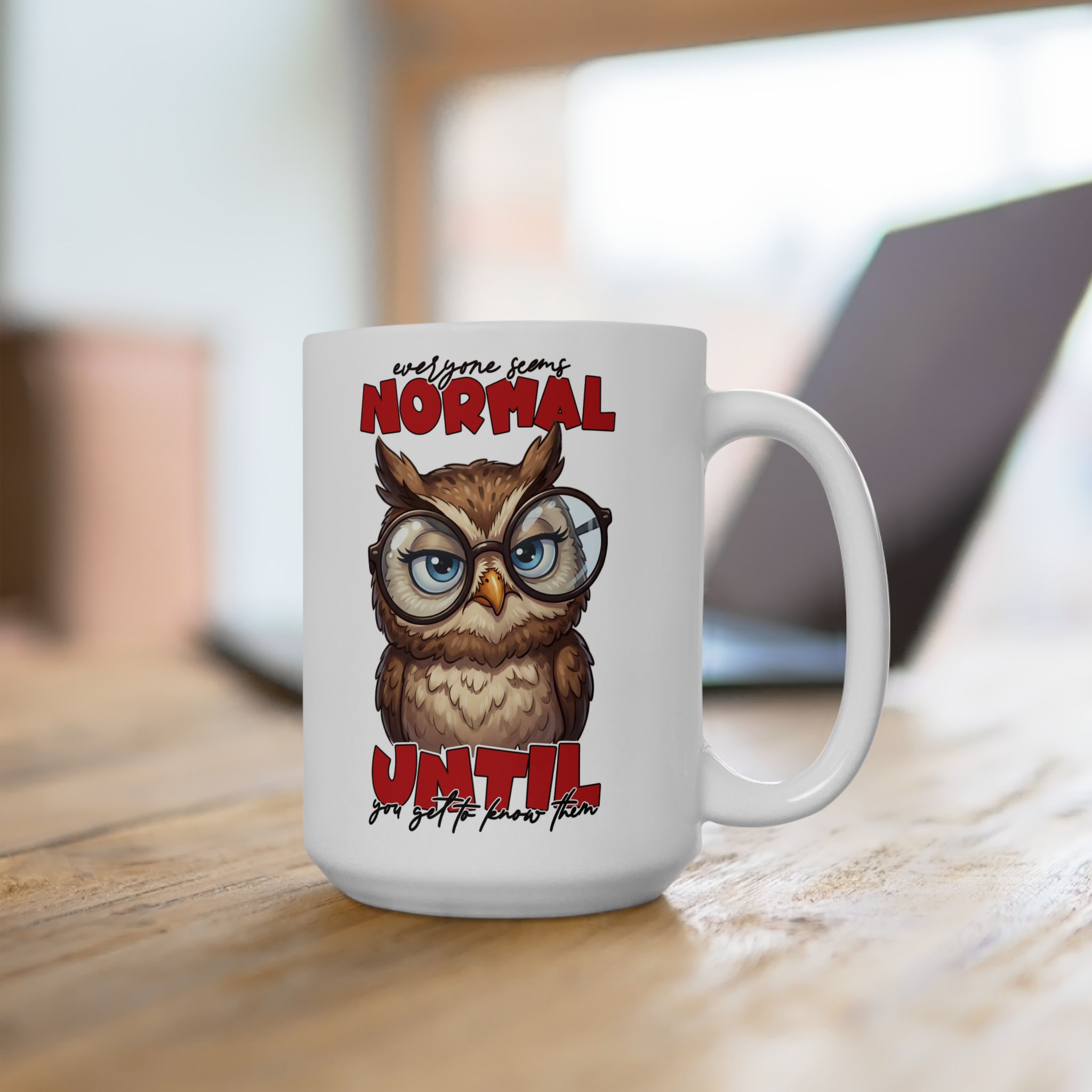 White ceramic mug with a cartoon owl wearing glasses and text that reads "Everyone seems normal until you get to know them."