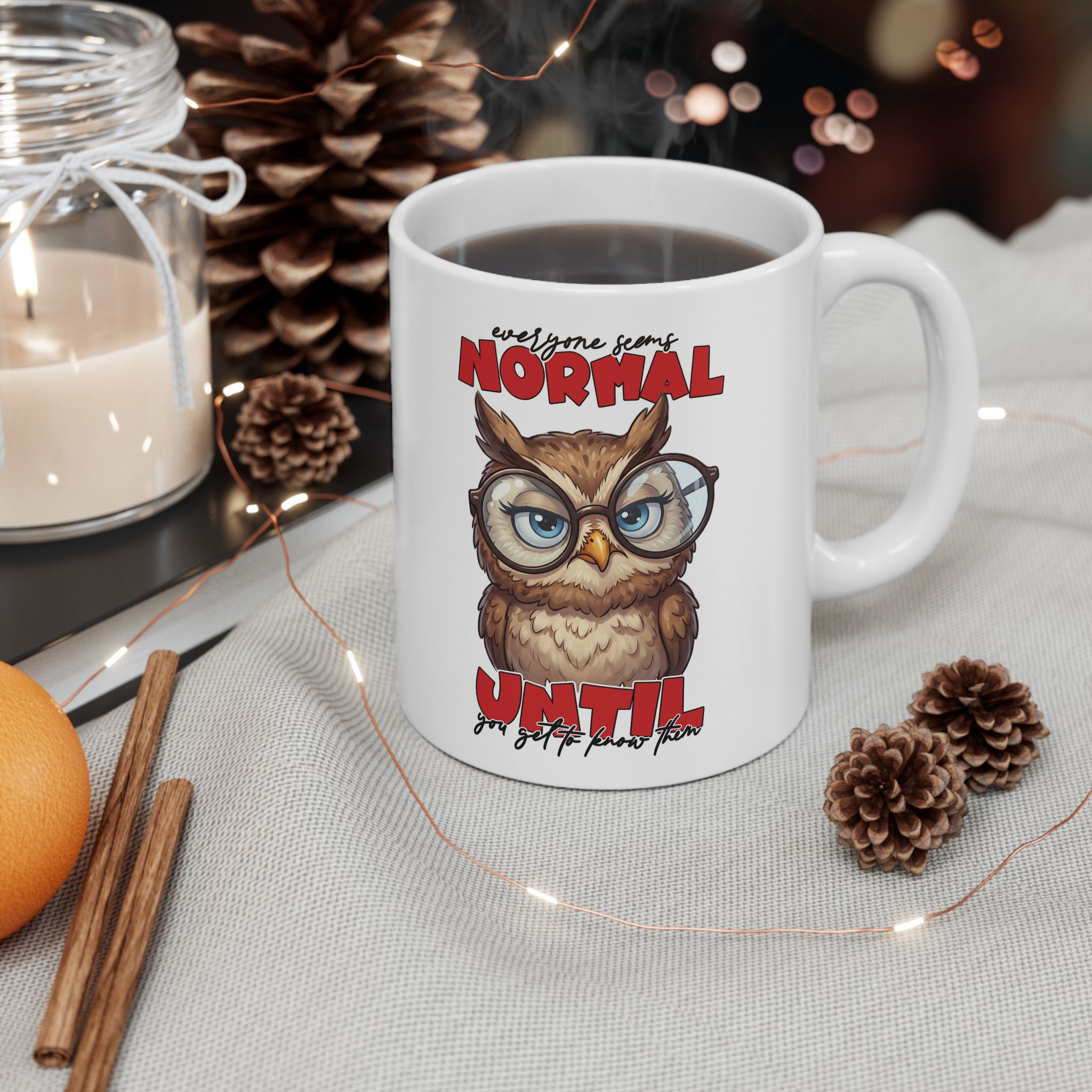 White ceramic mug with a cartoon owl wearing glasses and a funny saying in red.
