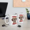 White ceramic mug with a grumpy cartoon dog wearing glasses and text.