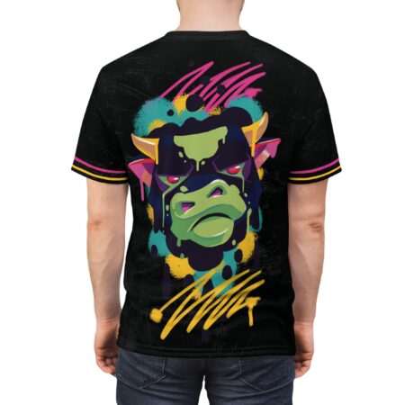 Splashes of teal, yellow, pink, and purple cover this patterned tee shirt, featuring a green bull with red eyes and dripping paint.