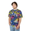 This all over print t-shirt features a vibrant graffiti style graphic with a blue cartoon monster and colorful abstract elements.
