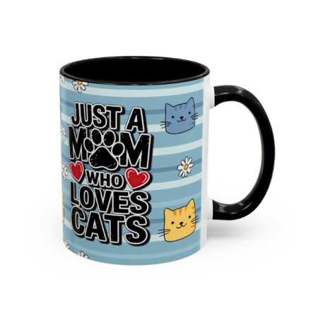 White ceramic mug with black handle and interior, featuring blue stripes, cartoon cats, paw print, and text.