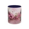 Ceramic coffee mug with a floral design and text 'Just A Mom Who Loves Dogs', featuring pink flowers and gold splatters.