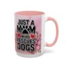 White coffee mug with pink interior and handle features 'Just a Mom Who Rescues Dogs' text and floral graphics.