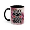Ceramic coffee mug with floral watercolor design, stating 'JUST A MOM WHO RESCUES DOGS' with paw print accent.
