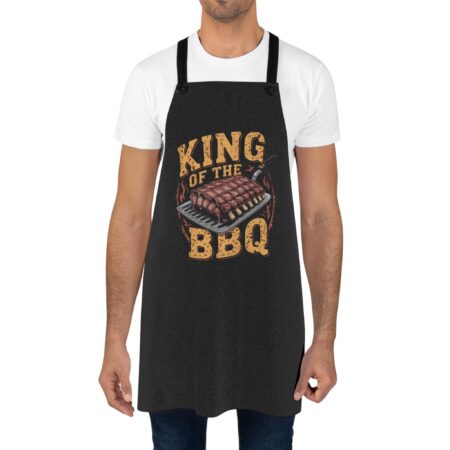Black apron with 'King of the BBQ' text and grilled ribs graphic, perfect for grilling enthusiasts.