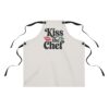 Light colored apron with 'Kiss the Chef' graphic and red lips motif.