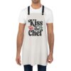 Kiss the Chef apron featuring a bold graphic with red lips and green leaves.