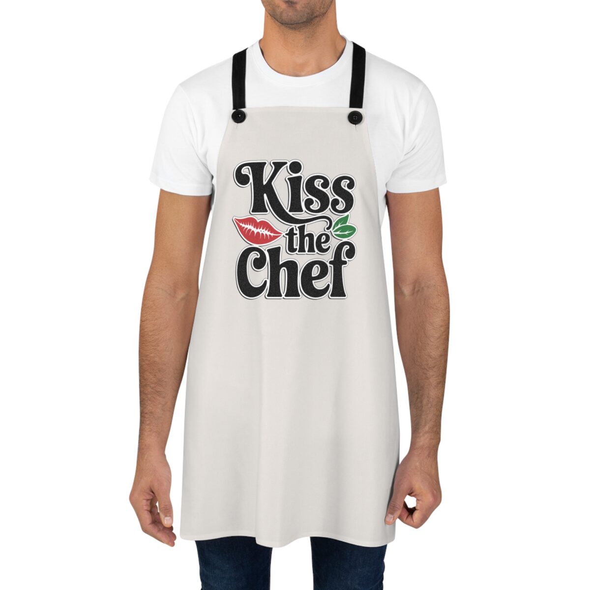 Kiss the Chef apron featuring a bold graphic with red lips and green leaves.