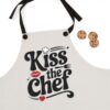 Light grey apron graphic text 'Kiss the Chef' with red lips, chef hat, fork, and heart accents for cooking enthusiasts.