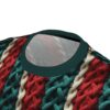 Red, teal, and cream braided knit patterns cover this tee shirt, mimicking a chunky sweater design.