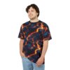 Model wearing a t-shirt with a vibrant lava flow pattern. The design features dark blue and black with bright orange and yellow cracks.