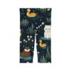 Children's leggings with a dark blue background, featuring a repeating pattern of cute cats, yellow ducks, white daisies, and green reeds in water.