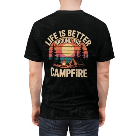 Distressed black fabric covers this 3D graphic t-shirt, depicting a sunset scene with a campfire, tent, and pine trees.