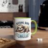 Ceramic coffee mug with a white body, green handle, and a sloth illustration that says "Natural Born Chiller".