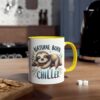 White ceramic mug with yellow handle, featuring a sleeping sloth on a branch with leaves and the words "NATURAL BORN CHILLER."