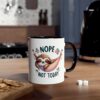 White mug with a black handle, featuring a cute sloth sleeping in a hammock with the words "Nope Not Today".