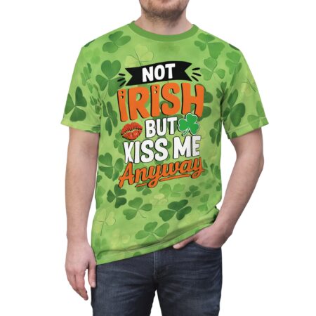 Green shamrocks and a playful kiss graphic cover this tee shirt, with bold text that reads "NOT IRISH BUT KISS ME ANYWAY".