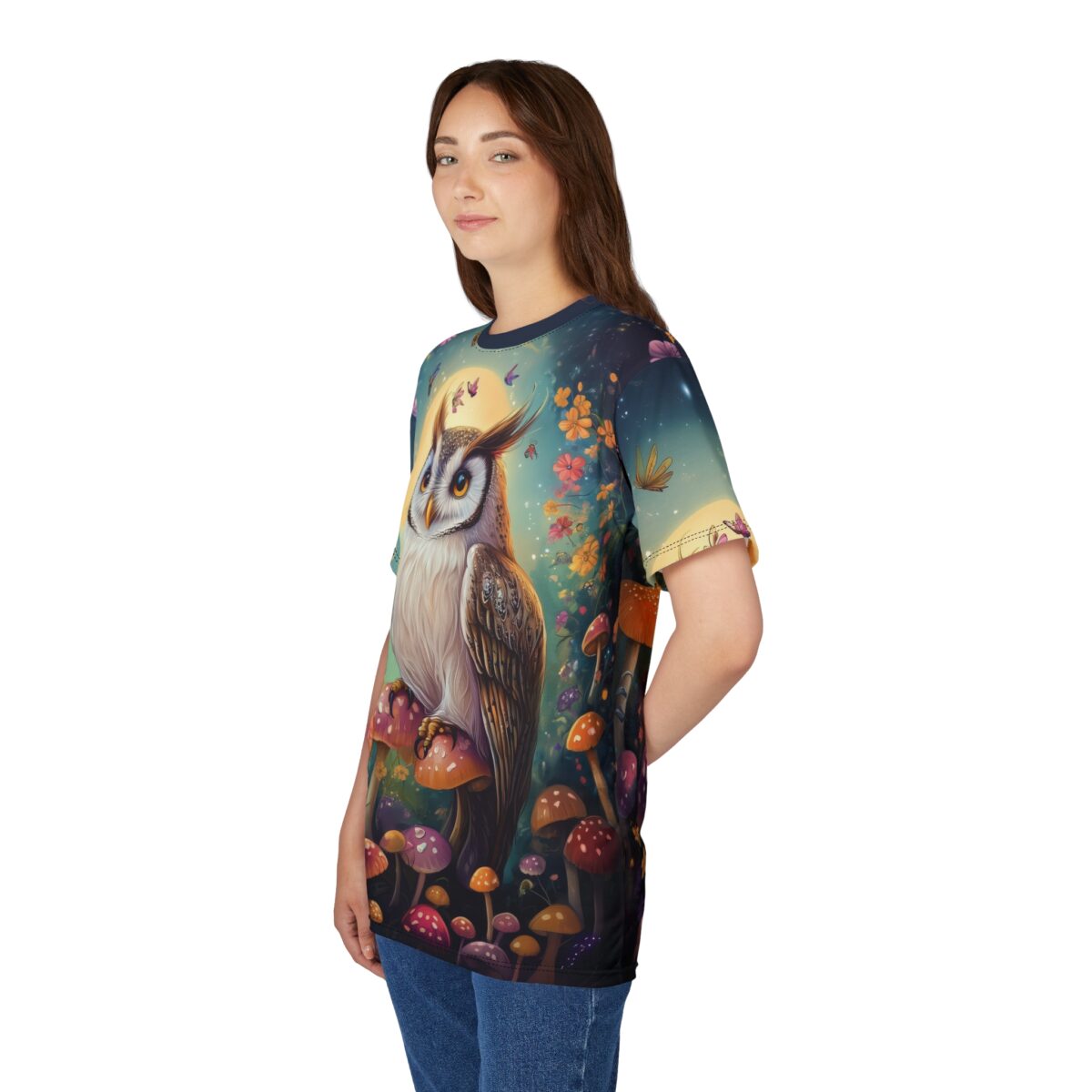 Vibrant oranges, purples, and greens cover this sublimation graphic tee, depicting a wise owl perched on mushrooms with butterflies and flowers.