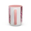 White ceramic mug with pink floral design and "Best Nana Ever" text, featuring a pink handle.