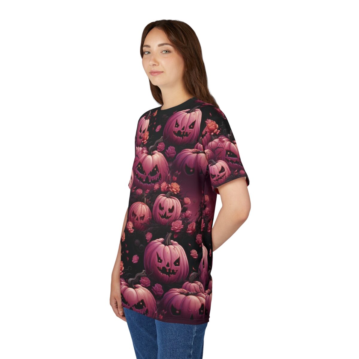 A woman wearing a black t-shirt with a repeating pattern of pink, carved Halloween pumpkins and roses.