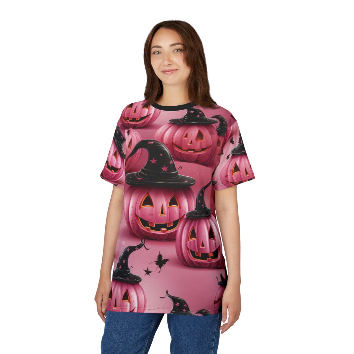 Pink pumpkins with black witch hats and stars cover this 3D graphic t-shirt, with bats in the background.