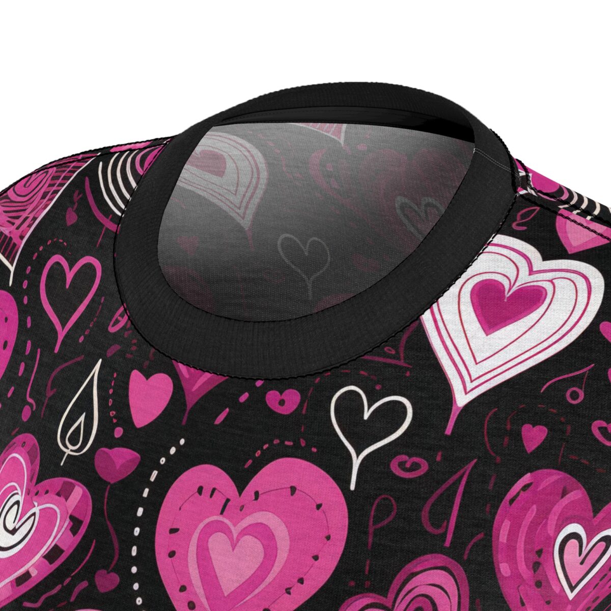 Black sublimation tee with all-over print of pink and white hearts and doodle motifs.