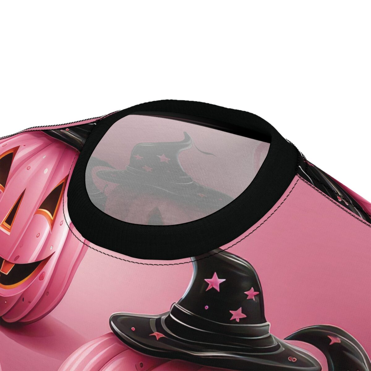 Pink pumpkins, black witch hats with pink stars, and spooky faces cover this all over print apparel, on a gradient pink background.