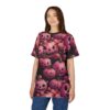 A woman wearing a black t-shirt with a repeating pattern of pink jack-o-lanterns and pink roses.
