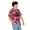 Pink pumpkins with carved faces and black witch hats cover this all over print apparel, with small black bats and stars in the background.