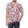 Pink, white, and black skulls and floral elements cover this seamless pattern tee, with delicate flowers and branches interspersed.