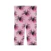 A pair of light pink leggings covered in a repeating pattern of black spiders, offering a playful yet spooky style.