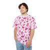 Bright pink and soft pink abstract shapes cover this seamless pattern tee, set against a crisp white background.
