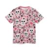 Pink, black, and white floral and skull patterns cover this graphic streetwear tee, showcasing Day of the Dead motifs with intricate detailing.