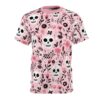 Pink and black floral patterns and skulls cover this sublimation graphic tee, showcasing a vibrant Day of the Dead design.