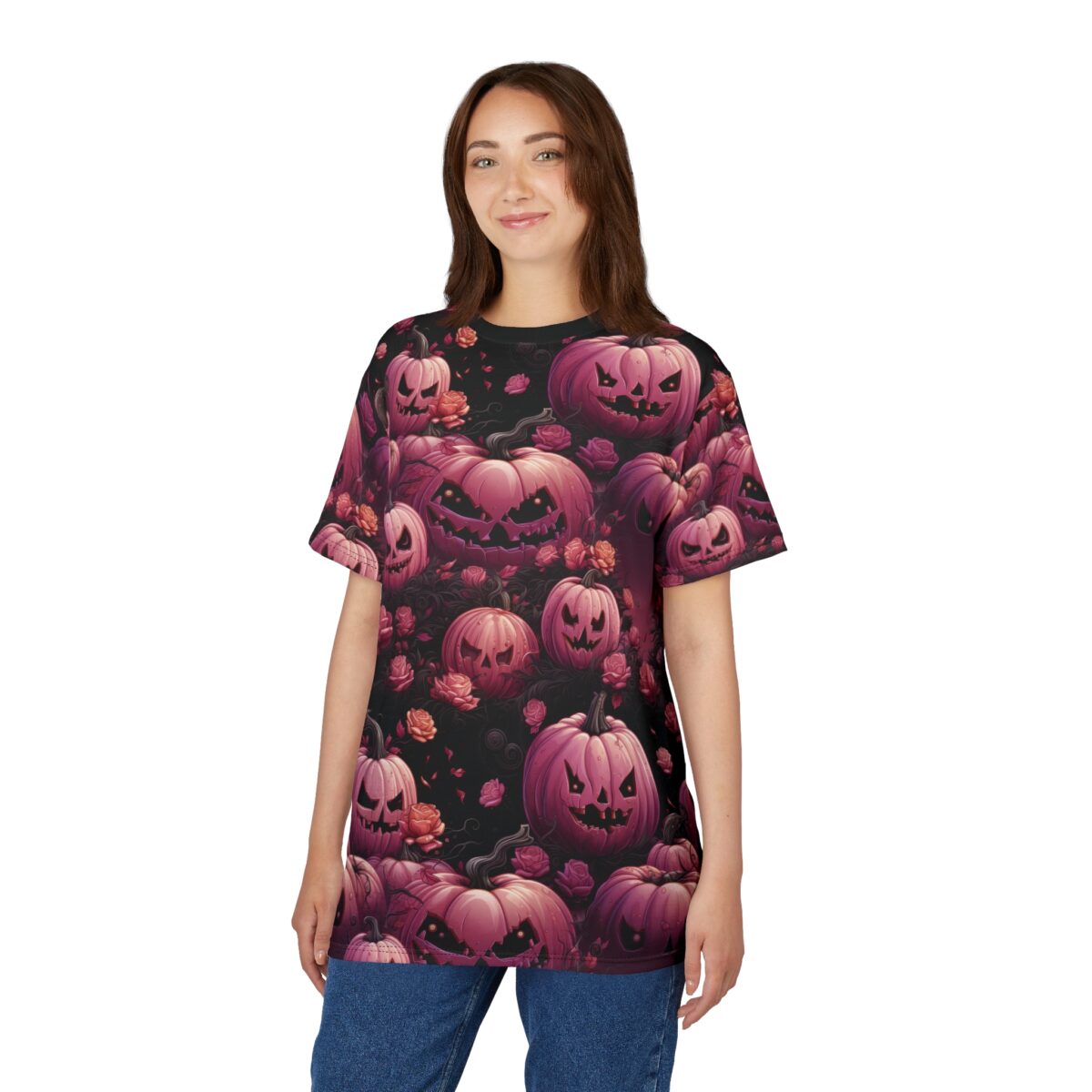 A young woman wearing a black t-shirt with a repeating pattern of pink Halloween pumpkins and roses.