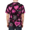 Back view of a person wearing a black t-shirt with a repeating pattern of various pink and white hearts of different sizes and styles.