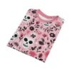Pink and white skulls with black details, alongside pink and black floral elements, cover this all over print t-shirt.