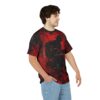 Red and black abstract paint strokes cover this graphic streetwear tee, featuring a silhouette of a musician playing guitar.
